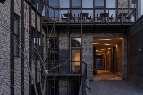 a building with a balcony with chairs on it at The Hide in Ghent
