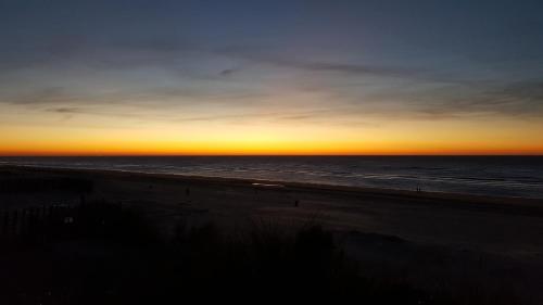 a view of the beach at sunset at Near the Beach in Zandvoort
