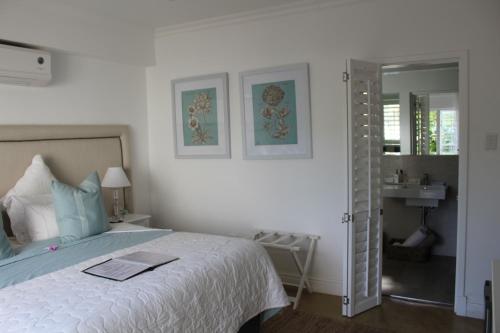 a bedroom with a bed with a book on it at Sandals Guest House in Durban