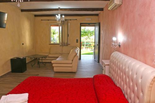 a living room with a couch and a red rug at Villa Paladino - B&B e Guest House in Scilla