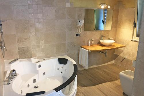 a bathroom with a bath tub and a sink at Villa Paladino - B&B e Guest House in Scilla