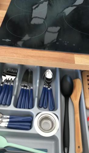 a drawer filled with cooking utensils on a shelf at 22B puigmal D in Empuriabrava