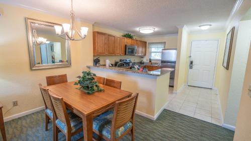 a kitchen and dining room with a wooden table and chairs at Blue Tree Resort at Lake Buena Vista in Orlando