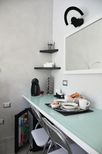 a counter with a table with a plate of food on it at Costantino Suites in Sorrento