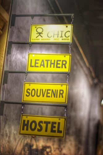 a group of yellow signs hanging on a wall at OK CHIC PHUKET HOSTEL in Phuket Town