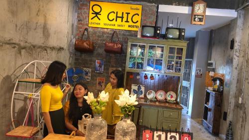 three women standing at a counter in a store at OK CHIC PHUKET HOSTEL in Phuket Town
