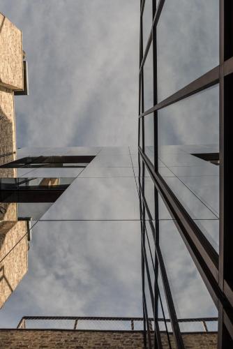 a reflection of the sky in the glass of a building at The Hide in Ghent