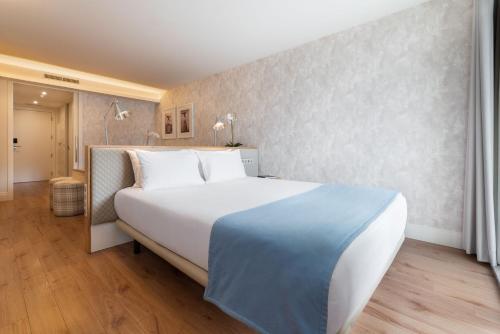 a bedroom with a large white bed in a room at Eurostars Porto Douro in Porto