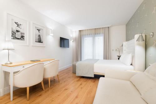 a hotel room with a bed and a desk and a couch at Eurostars Porto Douro in Porto