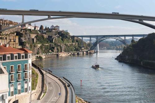 a boat on a river under a bridge at Eurostars Porto Douro in Porto