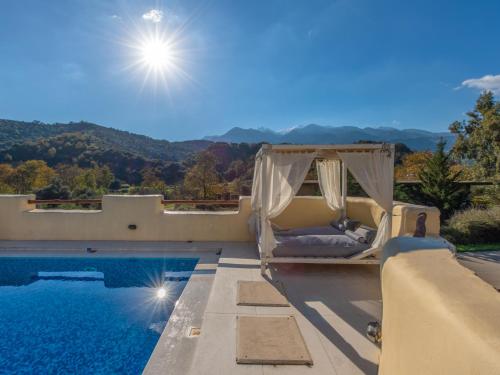 a villa with a swimming pool and a patio with a swing at Verekinthos Villas - Pool, Hot Tub, BBQ, Kids Playground, Stunning Mountain Views in Gerolakkos