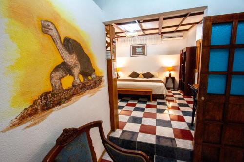 a room with a dinosaur painting on the wall at Maytenus Galapagos in Puerto Ayora