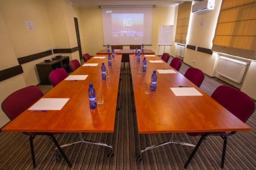 a conference room with a long wooden table with chairs at Optima Cherkasy Hotel in Cherkasy