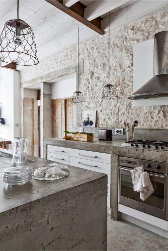 a kitchen with white cabinets and a stove top oven at Le392Bis in Échiré