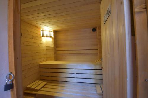 a sauna inside of a wooden cabin with a light at Къща Семково in Belitsa