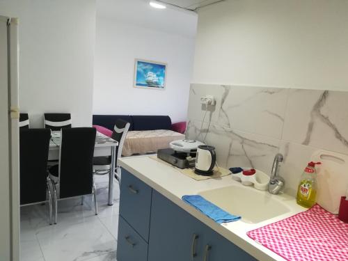 a kitchen with a sink and a counter top at Apartment By The Lake in Tiberias