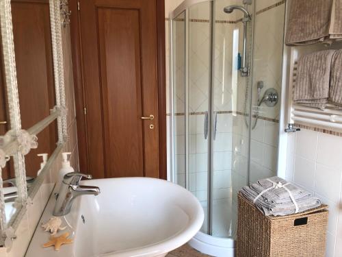 a bathroom with a tub and a shower and a sink at Appartamento Alla Riviera in Venice-Lido