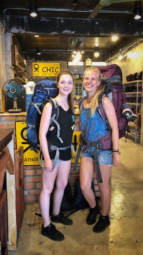 two women are standing next to a pile of luggage at OK CHIC PHUKET HOSTEL in Phuket Town