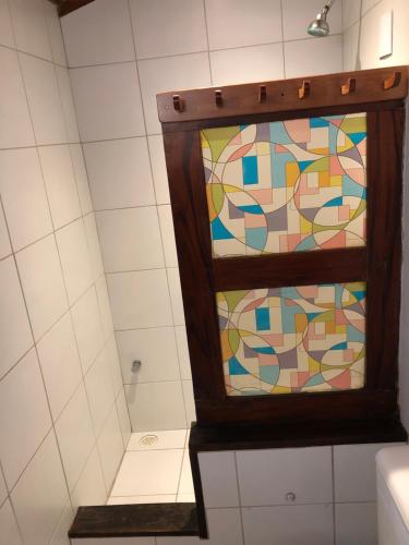 a bathroom with a shower with a stained glass window at Pousada e Restaurante do Paulo in Jijoca de Jericoacoara