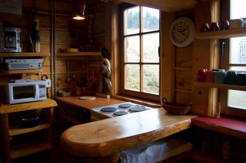 a kitchen with a counter and a stove and a window at Chata Koliba in Stará Ľubovňa