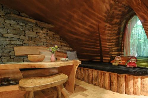 a room with a wooden table and a window at Omaya Eco Village in Gaytaninovo