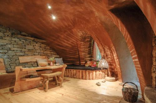 a room with a table and a bench in a cave at Omaya Eco Village in Gaytaninovo