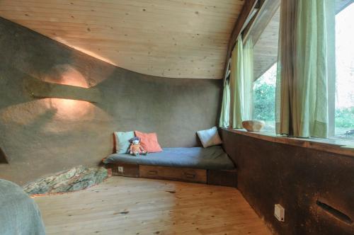 a room with a bed in a tree house at Omaya Eco Village in Gaytaninovo
