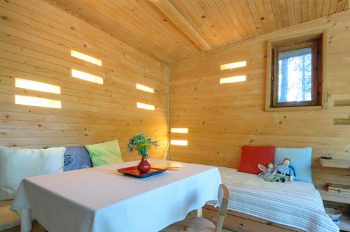 a room with a table in a log cabin at Omaya Eco Village in Gaytaninovo