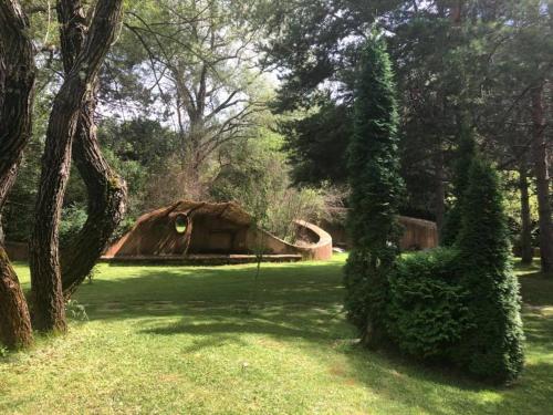 a house in the middle of a field with trees at Omaya Eco Village in Gaytaninovo