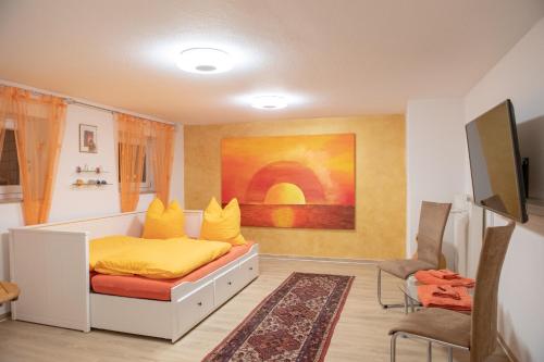 a bedroom with a bed with yellow pillows on it at Neanderland-Apartment in Wülfrath