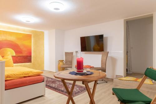 a living room with a table with a candle on it at Neanderland-Apartment in Wülfrath