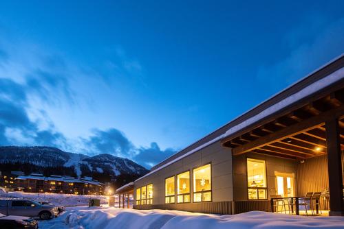 a building in the snow at night at Nowhere Special Hostel in Rossland