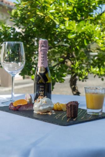 a bottle of champagne and a glass on a table at Best Western Plus Le Canard sur le Toit in Colomiers