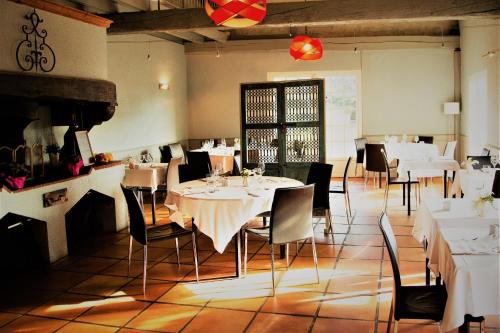 a dining room with white tables and chairs at Best Western Plus Le Canard sur le Toit in Colomiers