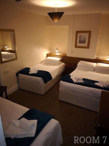 a hotel room with three beds in a room at Westgate Hotel in Oxford