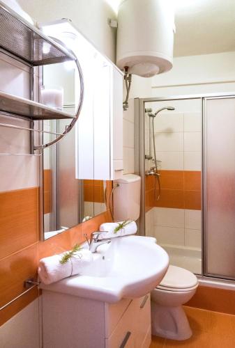 a bathroom with a sink and a toilet at Apartments Velo Lago in Lastovo