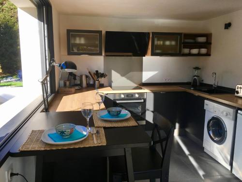 a kitchen with a table with two plates on it at Bed,Kitchen and Swimming Pool Villa Esterel in Saint-Raphaël