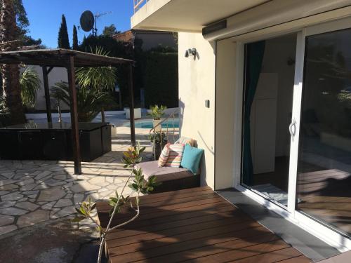 a sliding glass door with a bench on a patio at Bed,Kitchen and Swimming Pool Villa Esterel in Saint-Raphaël