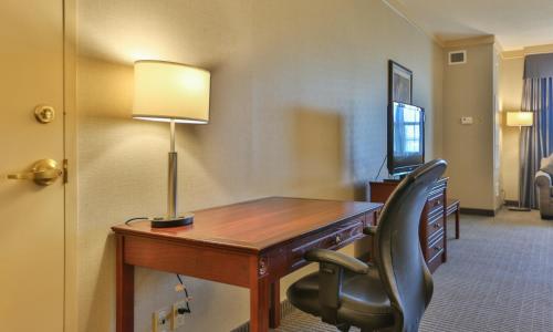 a desk with a lamp and a chair in a hotel room at Best Western Brantford Hotel and Conference Centre in Brantford