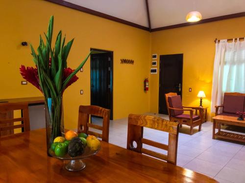 a vase of flowers on a table in a living room at Cordillera Escalera Lodge in Tarapoto