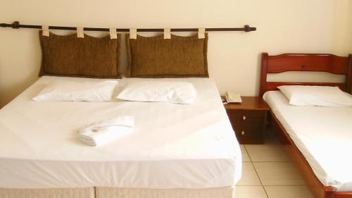 a bed with a computer mouse sitting on top of it at Hotel Alpinus in Joinville