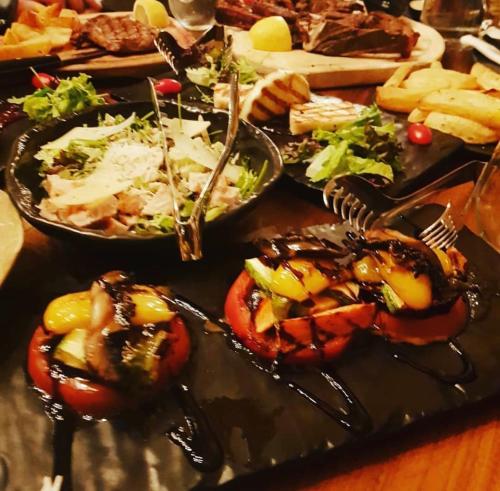 a table with several plates of food on a table at Mylaon Boutique Hotel & Spa in Vitina