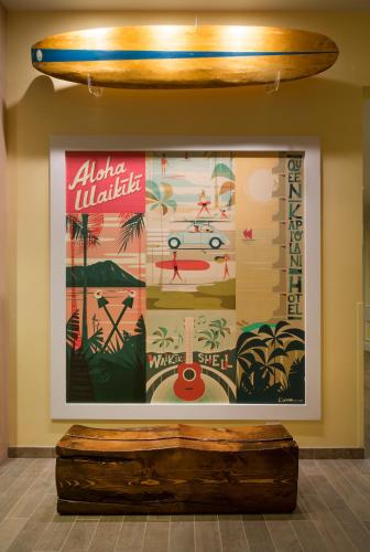 a large picture on a wall with a surfboard on it at Queen Kapiolani Hotel in Honolulu