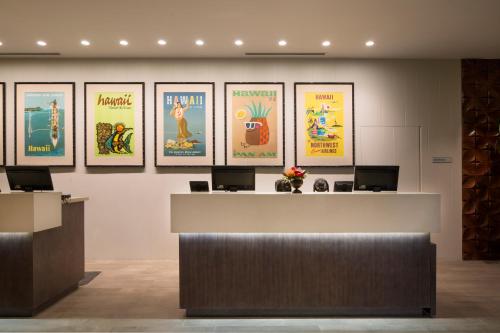 a lobby with four posters on the wall at Queen Kapiolani Hotel in Honolulu