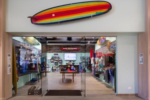 a store with a surfboard on the wall in a store at Queen Kapiolani Hotel in Honolulu