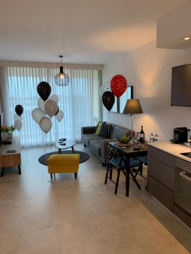 a living room with balloons and a couch at Different Atmosphere Suite in Caesarea