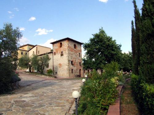 an old castle with a road in front of it at Borgo Antico Casalbosco Holiday Home & Winery in Santomato 