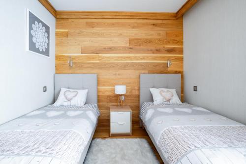 Posteľ alebo postele v izbe v ubytovaní Apartament Skrzyczne