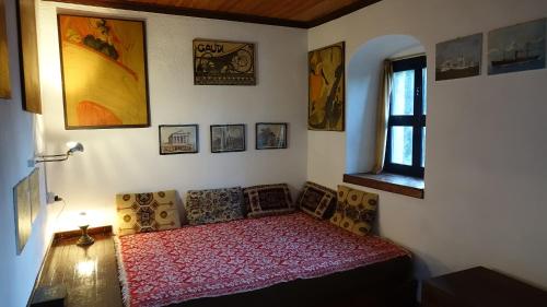 a bedroom with a bed and a window at The old olive mill house in Aegae