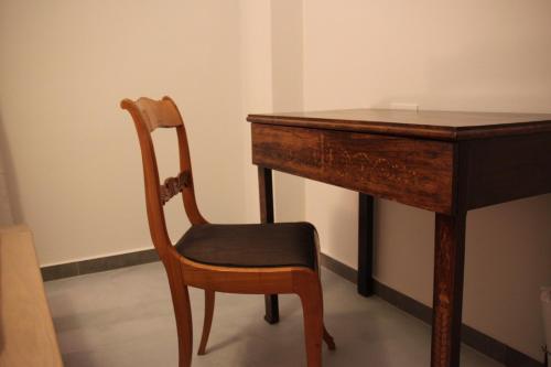 a wooden table with a chair next to a desk at Villa Pilali in Kefallonia